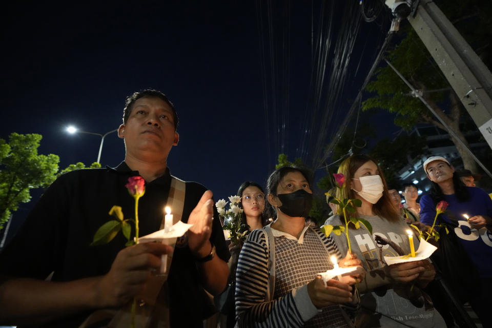 Thai activists hold candles during a vigil for Netiporn Sanesangkhom, a member of the activist group Thaluwang, known for their bold and aggressive campaigns demanding reform of the monarchy and abolition of the law that makes it illegal to defame members of the royal family, outside of Criminal court in Bangkok, Thailand, Tuesday, May 14, 2024. Netiporn who went on a hunger strike after being jailed for her involvement in protests calling for reform of the country's monarchy system died Tuesday in a prison hospital, officials said. (AP Photo/Sakchai Lalit)