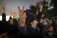 People gesture while listening to a speaker during a protest against the results of the Parliamentary election in Moscow, Russia, Monday, Sept. 20, 2021. The results in the other six regions that were allowed to vote online have been detailed. In Moscow, approval of the ruling party has always been particularly low and protest voting has been widespread. Candidates from the Communist Party called for demonstrations later in the day. (AP Photo/Pavel Golovkin)