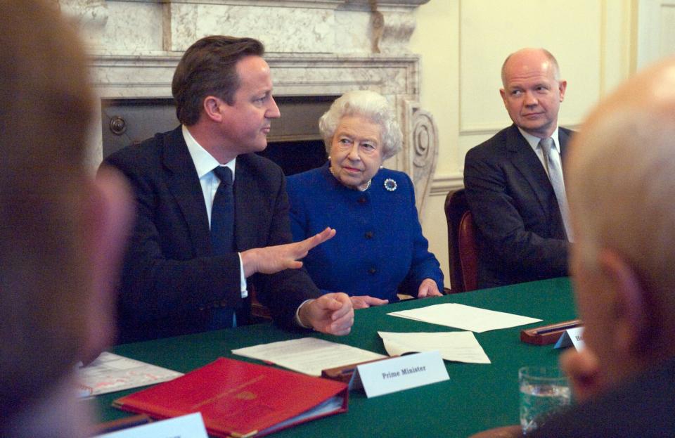 Britain's Queen Elizabeth II (C) and Foreign Secretary William Hague (R) listen as British Prime Minister David Cameron (L) makes introductory remarks at a Cabinet meeting inside No 10 Downing Street in London December 18, 2012. Queen Elizabeth II attended her first-ever cabinet meeting on Tuesday to mark her diamond jubilee, the only monarch to do so since 1781.The 86-year-old sovereign sat in as an observer on the meeting and received a gift from the Cabinet to celebrate her 60 years on the throne. AFP PHOTO / POOL / JEREMY SELWYN (Photo by JEREMY SELWYN / POOL / AFP)        (Photo credit should read JEREMY SELWYN/AFP via Getty Images)