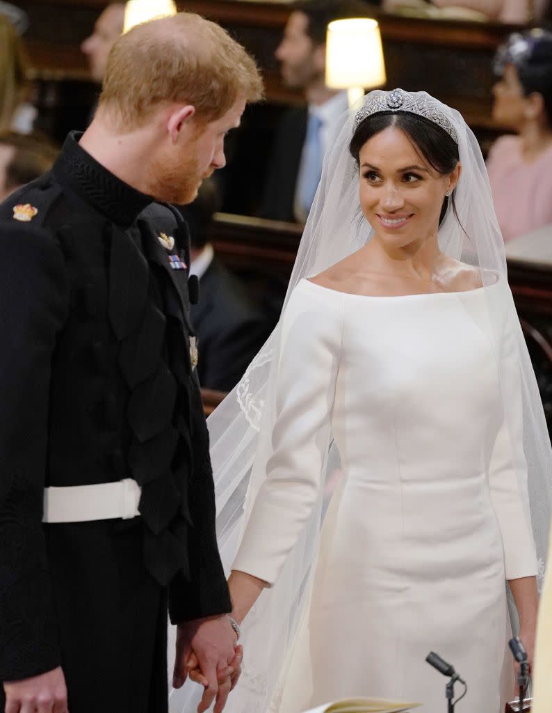 Prince Harry and Meghan Markle share a loving moment at their wedding.