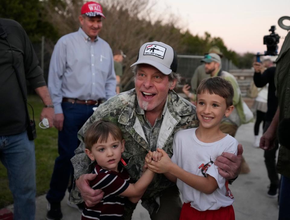 Rocker and political activist Ted Nugent poses for photos with children at the Take Our Border Back convoy rally.