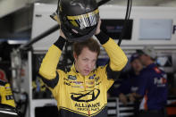 Brad Keselowski puts on his helmet during practice for Sunday's NASCAR Cup Series auto race at Charlotte Motor Speedway in Concord, N.C., Saturday, Sept. 28, 2019. (AP Photo/Gerry Broome)