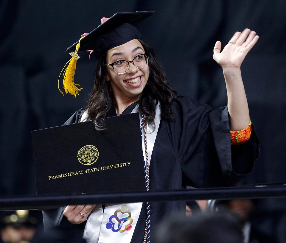 Samantha Riley Coombs gives a big smile to friends and family after receiving her diploma during the Framingham State University graduation ceremony at the DCU Center in Worcester, May 21, 2023.