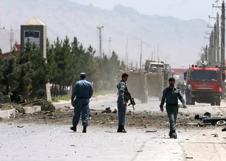 Afghan policemen stand guard at the site of a suicide attack in Kabul