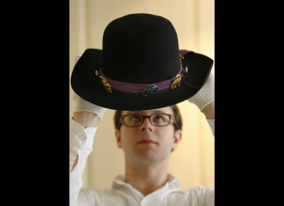 Museum employee Ralf Sternad poses with Jimi Hendrix's 'Westerner' hat.     AP Photo/Sang Tan