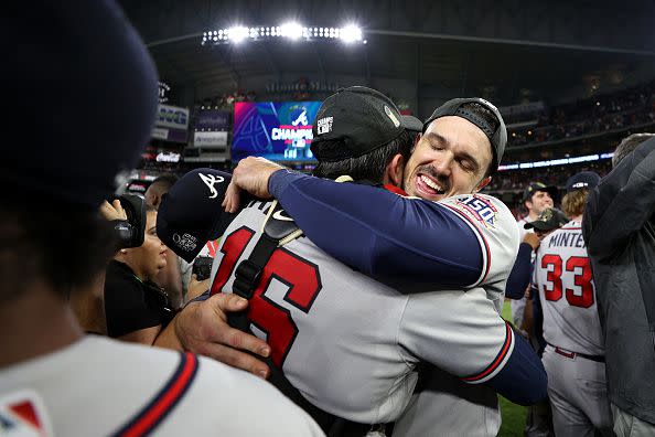 HOUSTON, TEXAS - NOVEMBER 02: Adam Duvall #14 hugs Travis d'Arnaud #16 of the Atlanta Braves after defeating the Houston Astros 7-0 in Game Six of the World Series at Minute Maid Park on November 02, 2021 in Houston, Texas. (Photo by Elsa/Getty Images)