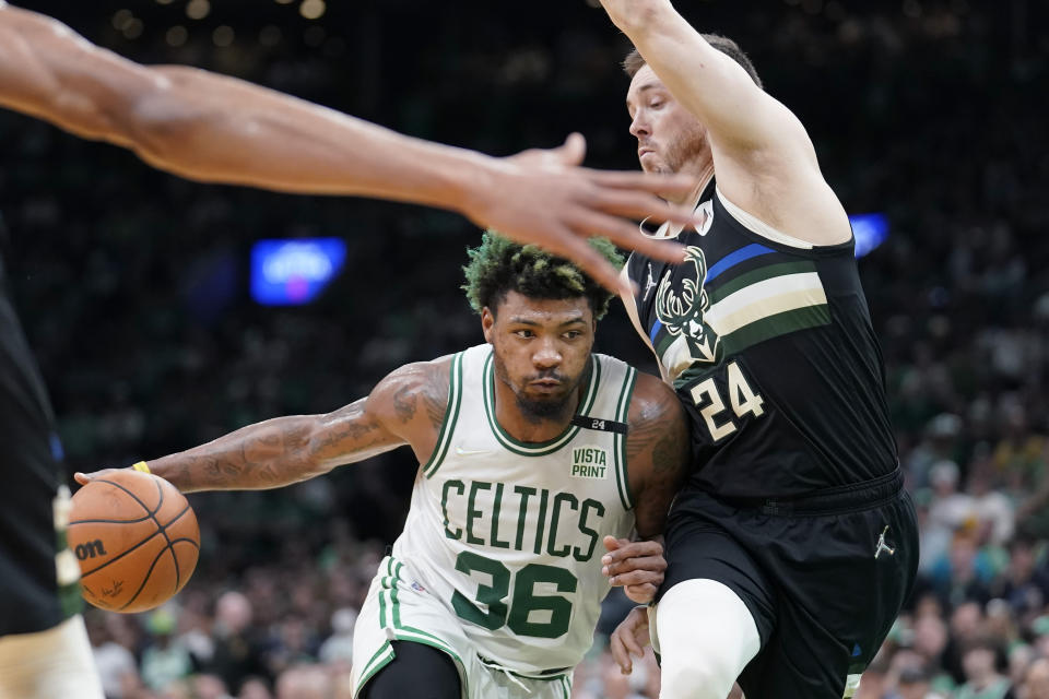 Boston Celtics guard Marcus Smart (36) drives as Milwaukee Bucks guard Pat Connaughton (24) tries to defend during the second half of Game 7 of an NBA basketball Eastern Conference semifinals playoff series, Sunday, May 15, 2022, in Boston. (AP Photo/Steven Senne)