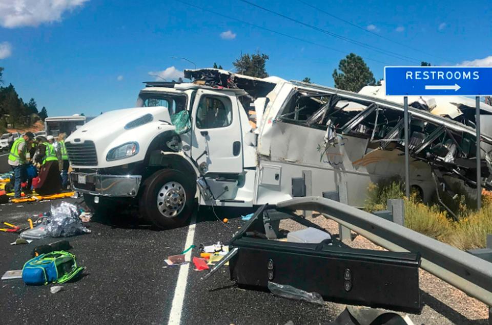 The bus was pictured hanging over guardrails on Utah's busy State Route 12 (AP)