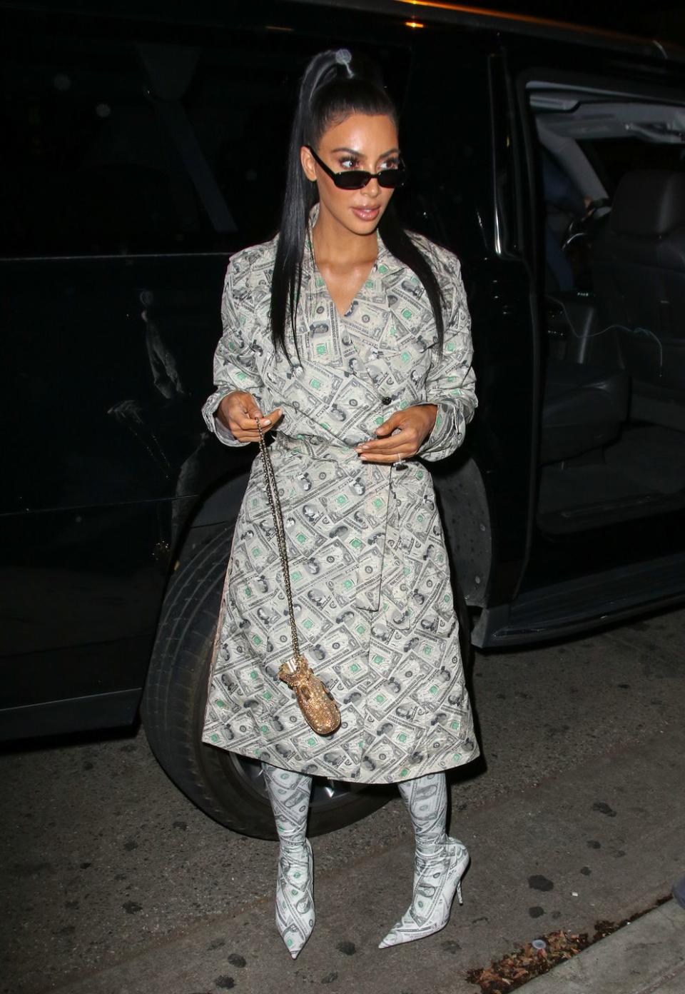 <p>In a 2001 Jeremy Scott money-printed trench coat, matching sock boots, and a Judith Leiber crystal "money pouch" bag for a party <a rel="nofollow noopener" href="https://www.harpersbazaar.com/celebrity/red-carpet-dresses/a23507837/kim-kardashian-money-outfit-anastasia-beverly-hills/" target="_blank" data-ylk="slk:celebrating Anastasia Beverly Hills.;elm:context_link;itc:0;sec:content-canvas" class="link ">celebrating Anastasia Beverly Hills. </a></p>