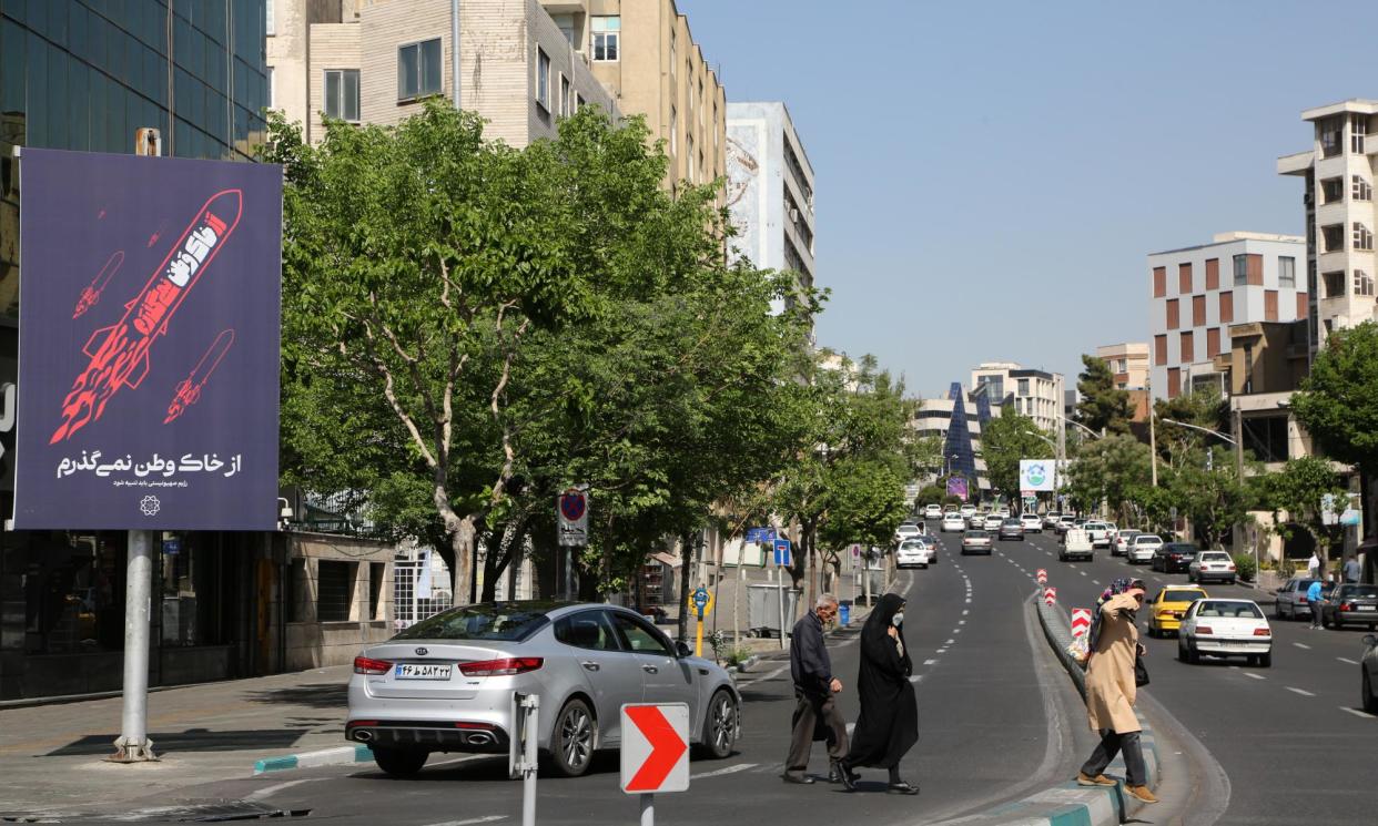 <span>People walk on the streets of Tehran as they continue their daily lives after the explosions heard in Isfahan and Tabriz.</span><span>Photograph: Anadolu/Getty Images</span>