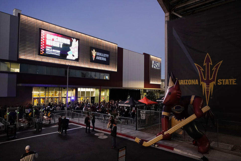 FILE - Arizona Coyotes fans wait for the doors to open prior to the Coyotes' home-opening NHL hockey game against the Winnipeg Jets at Mullett Arena in Tempe, Ariz., Oct. 28, 2022. The Coyotes are about to learn the fate of a proposed entertainment district that will include a new arena. A referendum going before voters in the city of Tempe will determine whether plans for the $2.3 billion Tempe Entertainment District will move forward. (AP Photo/Ross D. Franklin, File)