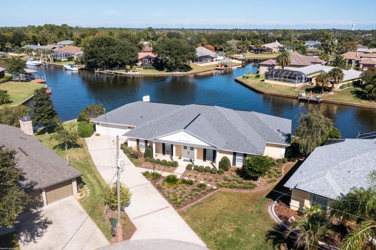 This custom-built Don Lowe home is beautifully placed where waterways cross paths in a sought-after section of Palm Coast.