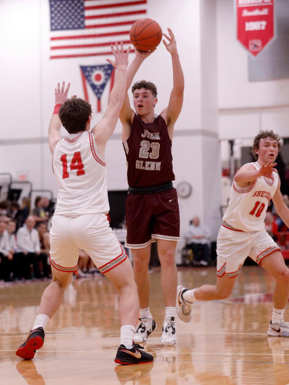 John Glenn's Nathan Walker looks for a teammate against Sheridan's Reid Packer on Friday night at Glen Hursey Gymnasium. Walker was among several area selections to the District 12 Coaches Association team.