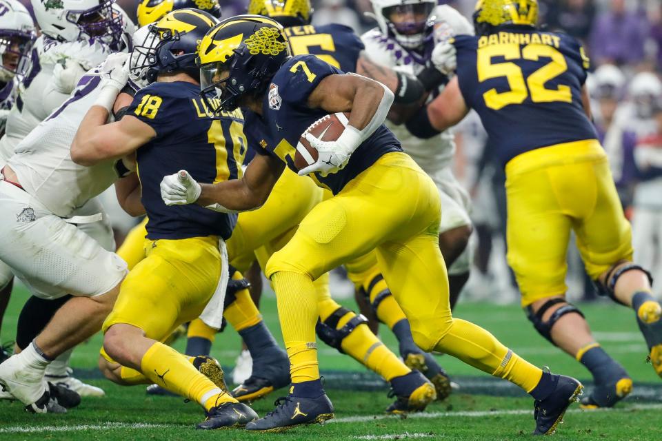 Michigan running back Donovan Edwards (7) runs against TCU during the first half at the Fiesta Bowl at State Farm Stadium in Glendale, Ariz. on Saturday, Dec. 31, 2022.