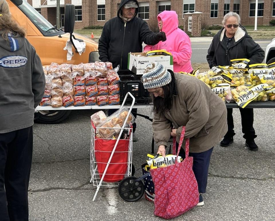 Betty Mays, of Enon, gets her cart ready to leave 'Free Food Friday,' an event sponsored by Beacon Hill Church, Friday, Feb. 2, 2024, in downtown Hopewell. Mays is one of hundreds of people who show up each week for the giveaway.