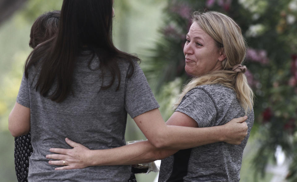 Women embrace during the funeral of Dawna Ray Langford, 43, and her sons Trevor, 11, and Rogan, 2, who were killed by drug cartel gunmen, at the cemetery in La Mora, Sonora state, Mexico, Thursday, Nov. 7, 2019. Three women and six of their children, related to the extended LeBaron family, were gunned down in an attack while traveling along Mexico&#39;s Chihuahua and Sonora state border on Monday. (AP Photo/Christian Chavez)