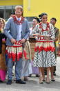 <p>They were given floral garlands while visiting an exhibition of Tongan handicrafts, mats and tapa cloths. Photo: Getty </p>