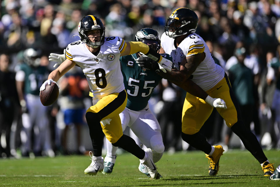 Pittsburgh Steelers quarterback Kenny Pickett (8) evades a tackle by Philadelphia Eagles defensive end Brandon Graham (55) during the first half of an NFL football game between the Pittsburgh Steelers and Philadelphia Eagles, Sunday, Oct. 30, 2022, in Philadelphia. (AP Photo/Derik Hamilton)