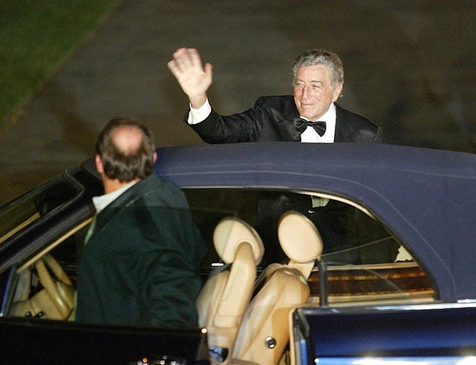 Singer legend Tony Bennett waves to crowd before entering church for Donald Trump’s wedding.