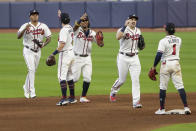 Atlanta Braves' Ozzie Albies (1) celebrates with teammates after Game 2 of a baseball National League Division Series against the Miami Marlins Wednesday, Oct. 7, 2020, in Houston. The Braves won 2-0. (AP Photo/Michael Wyke)