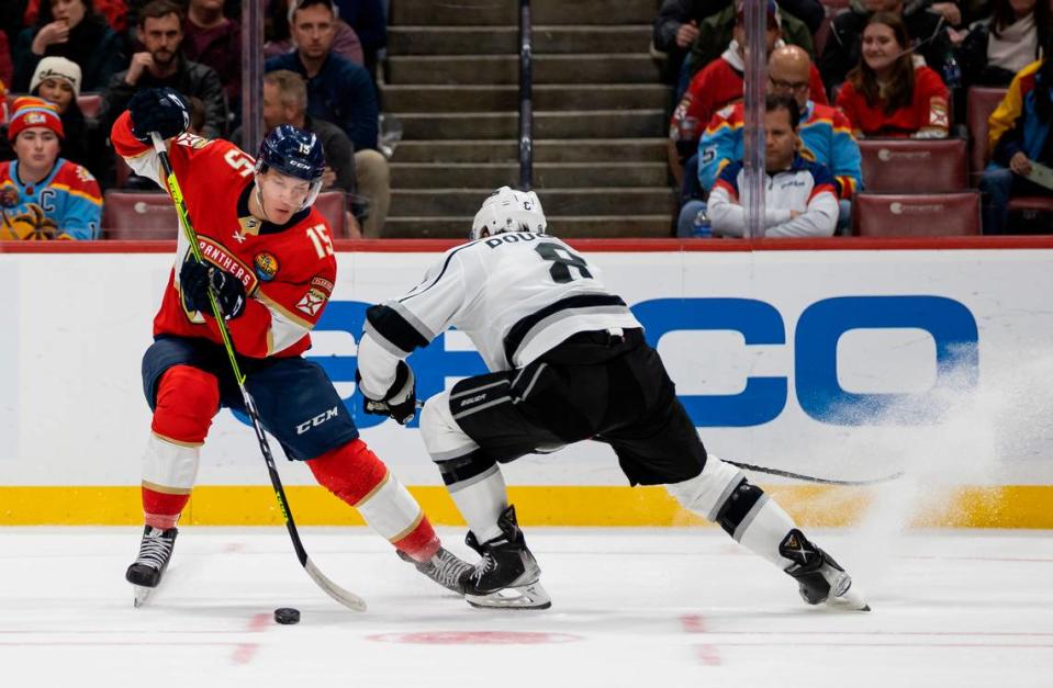 Florida Panthers center Anton Lundell (15) manages to make his way past Los Angeles Kings defenseman Drew Doughty (8) during the first period of an NHL game at the FLA Live Arena on Friday, Jan. 27, 2023, in Sunrise, Fla.