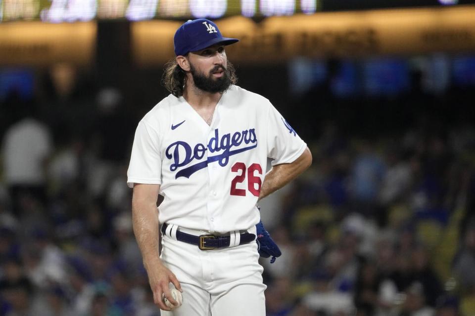 Dodgers pitcher Tony Gonsolin leans to his side and stares from the mound during a loss.