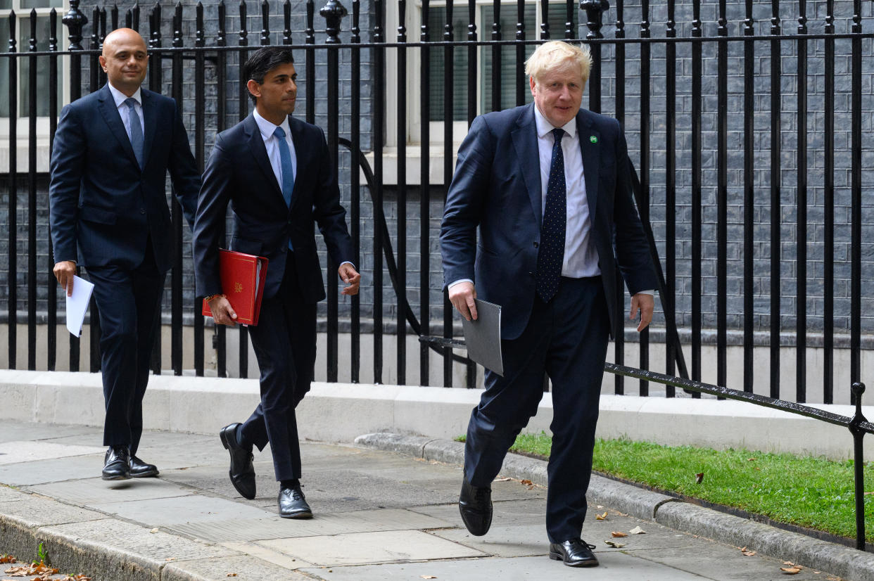 LONDON, ENGLAND - SEPTEMBER 07: Health Secretary Sajid Javid (L), Chancellor of the Exchequer Rishi Sunak (C) and Prime Minister Boris Johnson (R) walks towards the door of number 9, Downing Street ahead of a press conference on September 07, 2021 in London, England. Prime Minister Boris Johnson today announced a rise in national insurance to fix a social care crisis and a pandemic surge in hospital waiting lists. (Photo by Leon Neal/Getty Images)