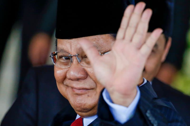 FILE PHOTO: Indonesia's losing presidential candidate Prabowo Subianto gestures as he arrives to attend the inauguration of Indonesia's President Joko Widodo for the second term, at the House of Representatives building in Jakarta