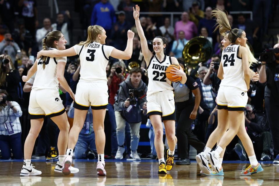 Iowa Hawkeyes guard Caitlin Clark (22) celebrates with teammates after defeating the LSU Lady Tigers in the finals of the Albany Regional in the 2024 NCAA Tournament at MVP Arena in Albany on April 1, 2024.