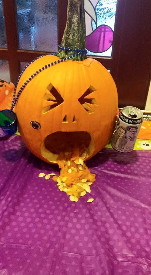 a jack-o-lantern puking out pumpkin guts