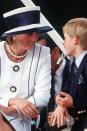 <p>With Prince Harry in a navy-and-white structured top hat.</p>