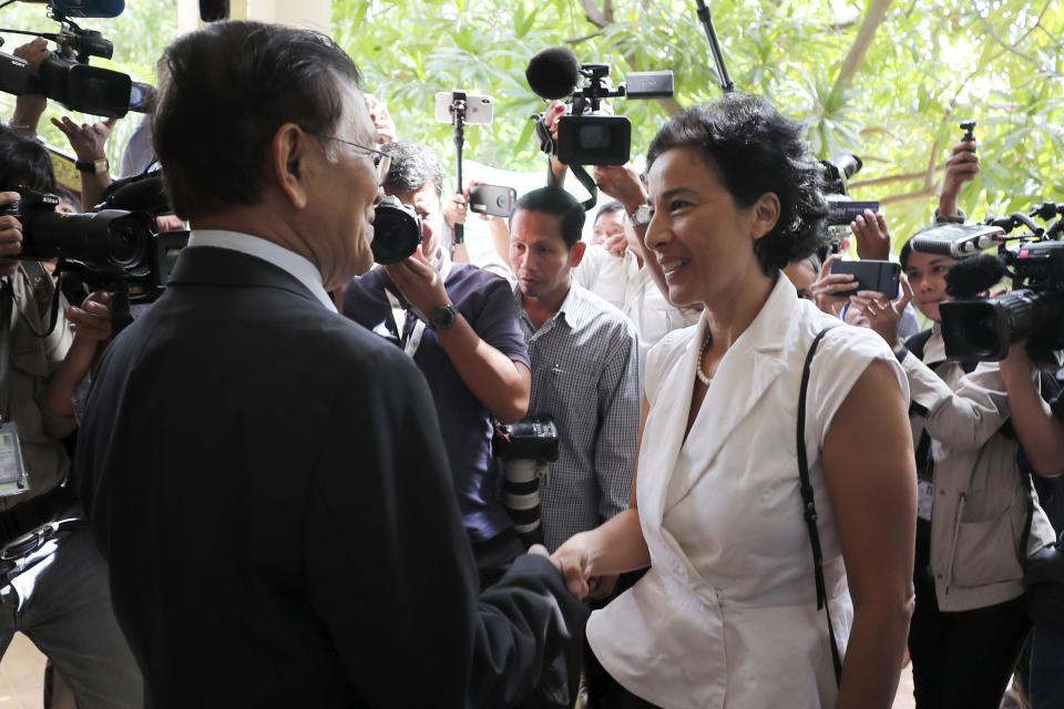 Cambodia National Rescue Party's President Kem Sokha, front left, shakes hands with French Ambassador to Cambodia Eva Nguyen Binh, front right, before a meeting at his house in Phnom Penh, Cambodia, Monday, Nov. 11, 2019. A Cambodian court has lifted some restrictions on detained opposition leader Kem Sokha, essentially ending his house arrest. (AP Photo/Heng Sinith)