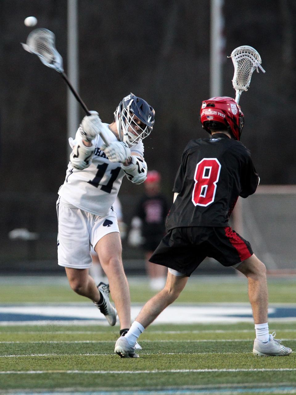 Granville's Colt Shaw passes the ball past St. Charles' Connor Brandt Tuesday, March 21, during the Blue Aces' 11-10 loss. 