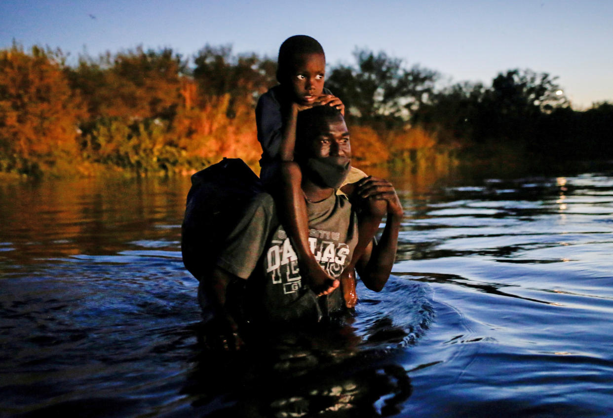 A migrant seeking refuge in the U.S. crosses the Rio Grande towards Del Rio, Texas, on Sept. 23, 2021. (Daniel Becerril / Reuters)