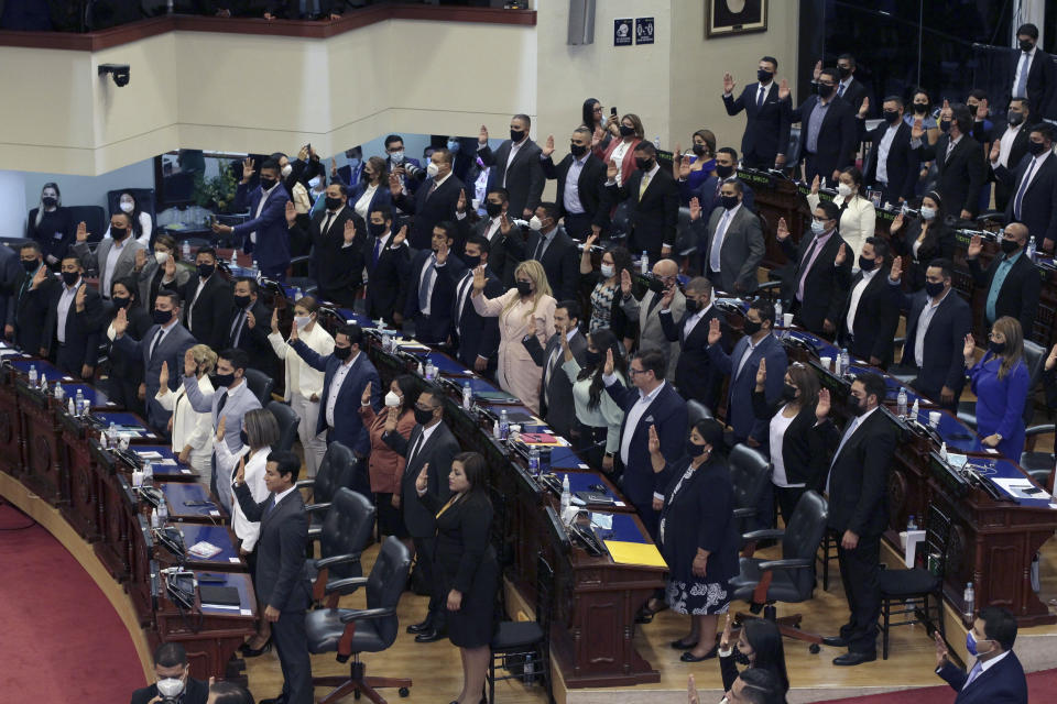 Ruling party New Ideas lawmakers are sworn-in at the Congress in San Salvador, El Salvador, Saturday, May 1, 2021. For the first time in three decades the traditional conservative and leftist parties have been sidelined by a resounding electoral defeat, clearing the way for President Nayib Bukele's party to help him advance his agenda. (AP Photo/Salvador Melendez)