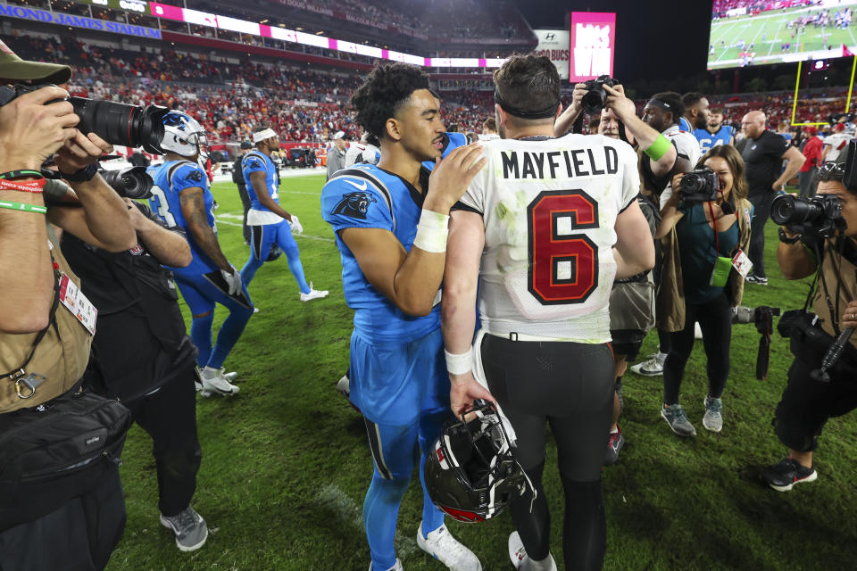 Tampa Bay Buccaneers quarterback Baker Mayfield greets Carolina Panthers quarterback Bryce Young after the Buccaneers win in an NFL football game Sunday, Dec. 3, 2023, in Tampa, Fla. (AP Photo/Mark LoMoglio)