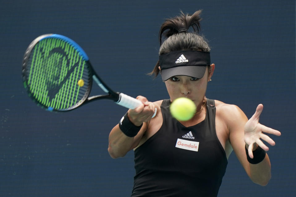 Wang Qiang of China returns a shot from Coco Gauff, during the Miami Open tennis tournament, Friday, March 25, 2022, in Miami Gardens, Fla. (AP Photo/Wilfredo Lee)