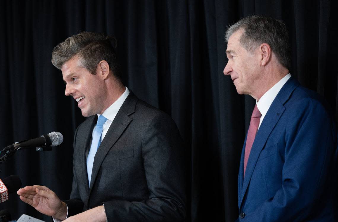 N.C. Department of Health and Human Services Secretary Kody Kinsley, left, joined Gov. Roy Cooper at a news conference in Charlotte to discuss state efforts to relieve the burden of medical debt.