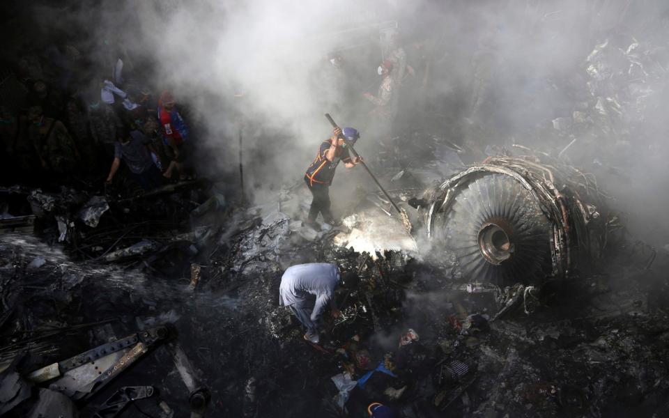 Volunteers look for survivors of the plane crash - AP Photo/Fareed Khan