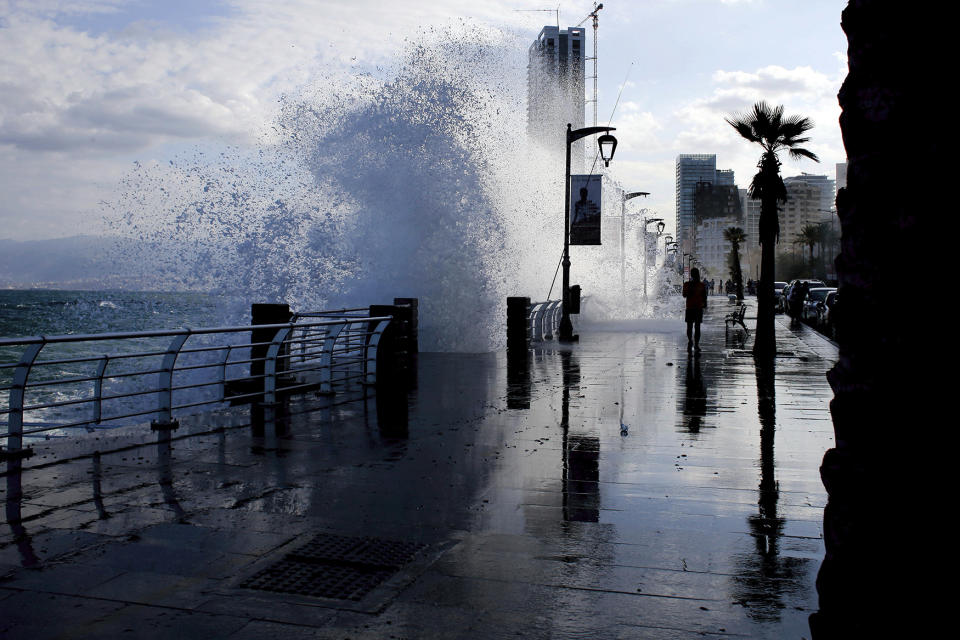 Lebanese man runs as waves crash in Beirut