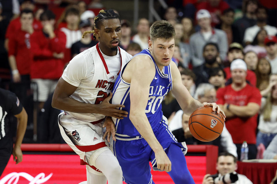 Duke's Kyle Filipowski (30) controls the ball in front of North Carolina State's Greg Gantt during the second half of an NCAA college basketball game in Raleigh, N.C., Wednesday, Jan. 4, 2023. (AP Photo/Karl B DeBlaker)