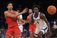 St. John's RJ Luis Jr. (12) passes the ball away from Seton Hall's Kadary Richmond (1) during the second half of an NCAA college basketball game in the quarterfinal round of the Big East Conference tournament, Thursday, March 14, 2024, in New York. (AP Photo/Frank Franklin II)