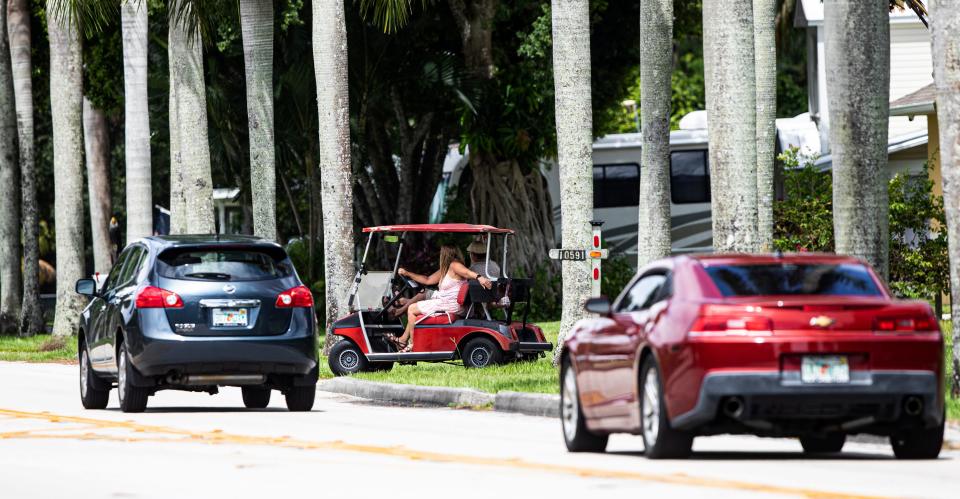 People use a golf cart for transportation along McGregor Boulevard just south of Colonial Boulevard in Fort Myers on Friday, Sept. 9, 2022.  