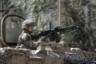 Resolute Support (RS) forces guard at the site of a car bomb explosion in Kabul, Afghanistan, Thursday, Sept. 5, 2019. The Afghan government says at least 10 civilians are dead and another 42 wounded after a Taliban suicide car bombing rocked the Afghan capital near a neighborhood housing the U.S. Embassy and the NATO Resolute Support mission. (AP Photo/Rahmat Gul)