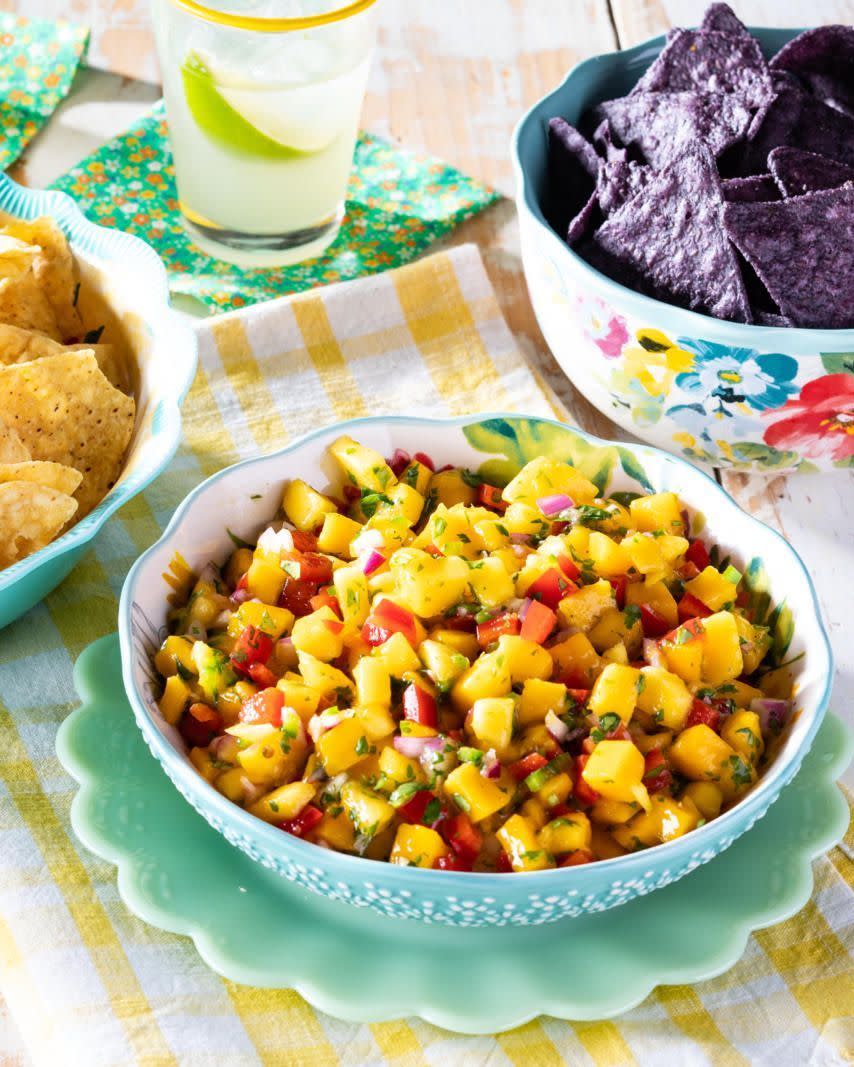 mango salsa in bowl with blue chips