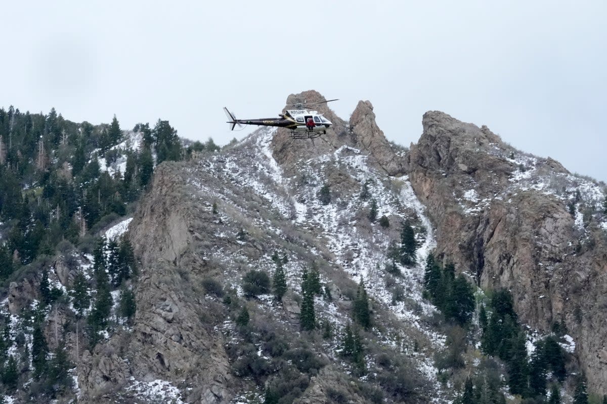 A Utah Department of Public Safety helicopter carries rescuers from Hidden Valley Park on 9 May 2024 in Sandy, Utah (AP)
