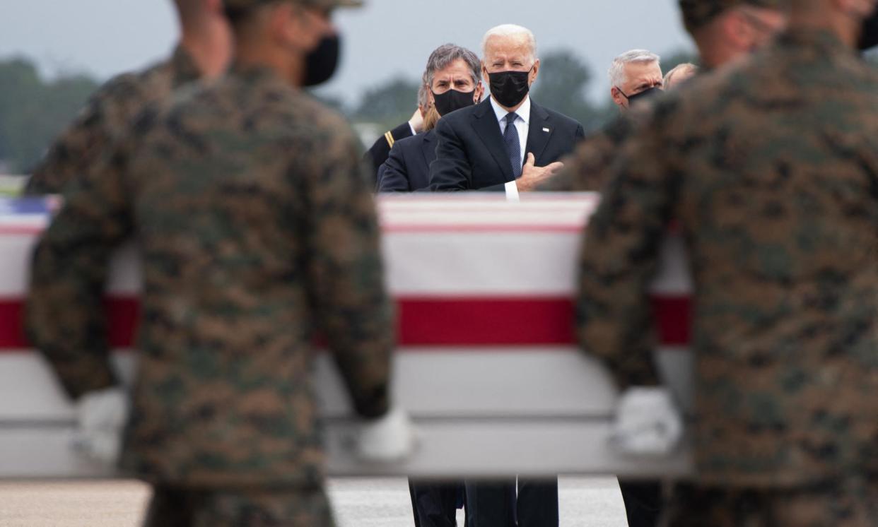 <span>Joe Biden attends the dignified transfer of remains of fallen service members at Dover air force base in Delaware on 29 August 2021.</span><span>Photograph: Saul Loeb/AFP/Getty Images</span>