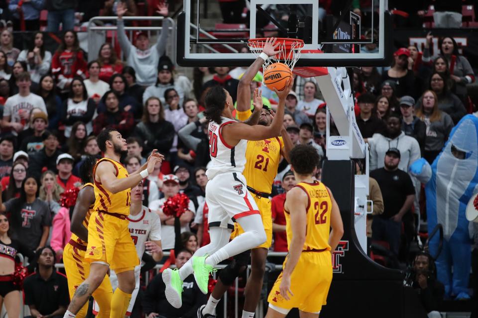 Jan 30, 2023; Lubbock, Texas, USA;  Texas Tech Red Raiders guard Jaylon Tyson (20) goes to the basket against Iowa State Cyclones center Osun Osunniyi (21) in the first half at United Supermarkets Arena. Mandatory Credit: Michael C. Johnson-USA TODAY Sports ORG XMIT: IMAGN-512080 ORIG FILE ID:  20230130_tdc_aj7_0239.JPG