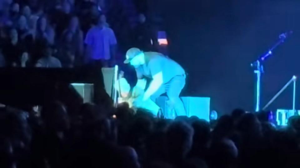 The rocker was helped back up by a security guard who rushed over immediately. Mitch Wight / YouTube