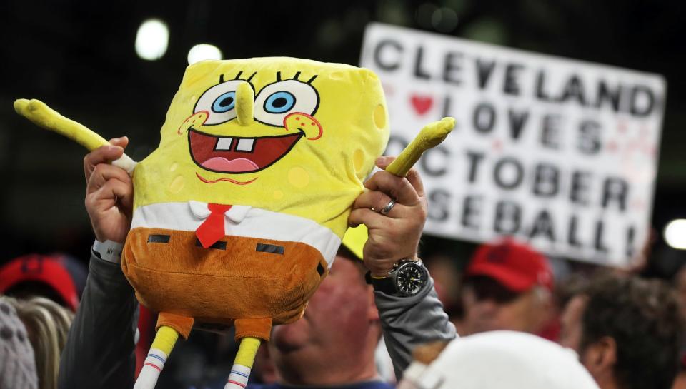 A fan of Cleveland Guardians right fielder Oscar Gonzalez holds up a stuffed "SpongeBob SquarePants" during the fourth inning of Game 4 of an American League Division baseball series against the New York Yankees in Cleveland on Oct. 16.